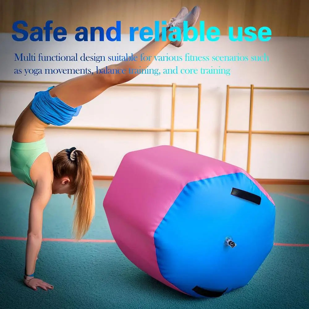 A pink and blue inflatable gym barrel used by a gymnast for core and balance training in a studio.