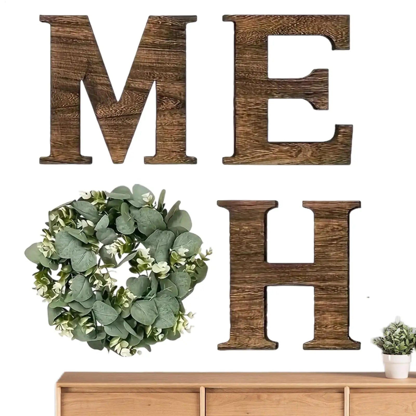 Rustic 'HOME' wall sign featuring dark wooden letters and a lush, artificial green eucalyptus wreath for the letter 'O'.