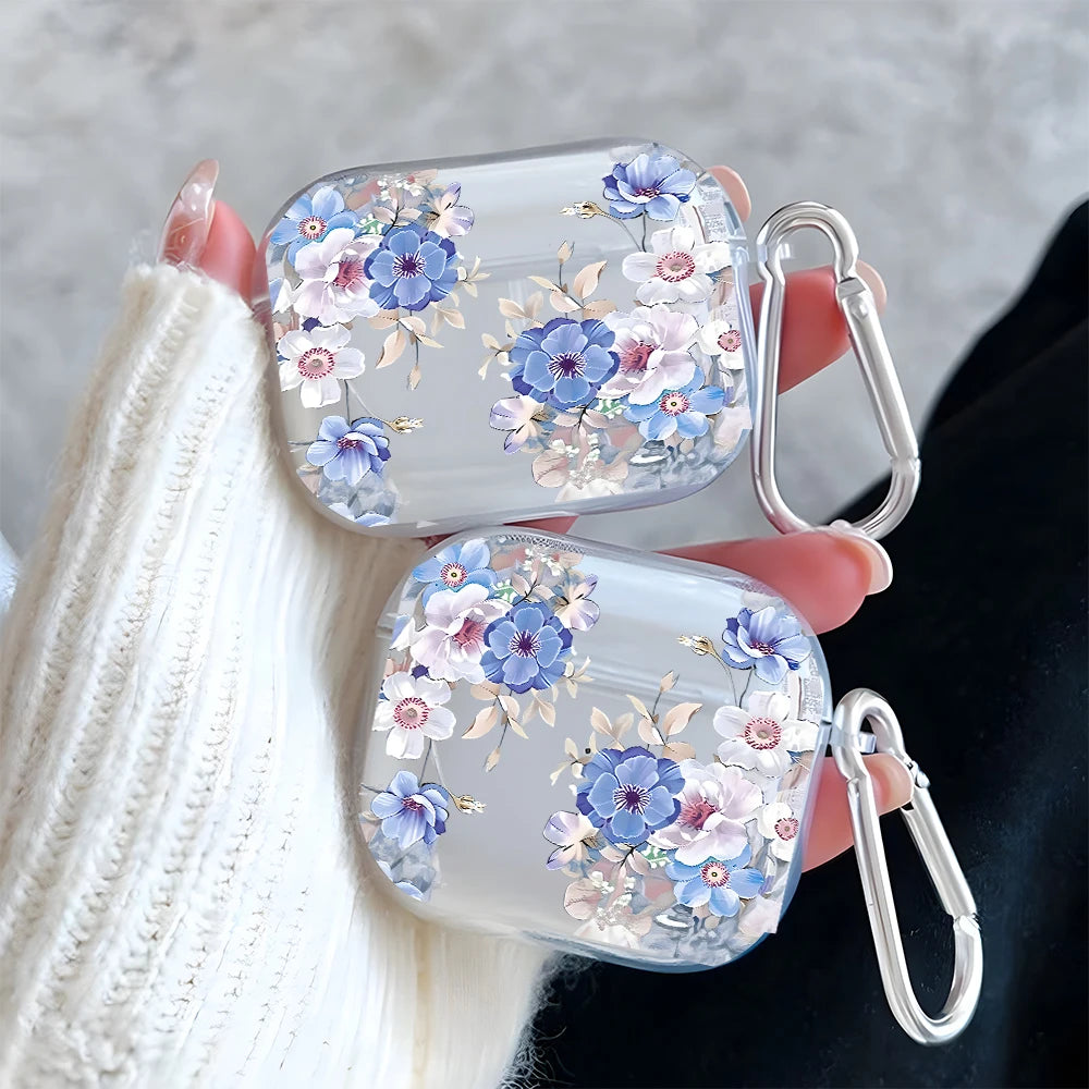 Clear protective case for AirPods with blue and white floral print and silver carabiner clip.