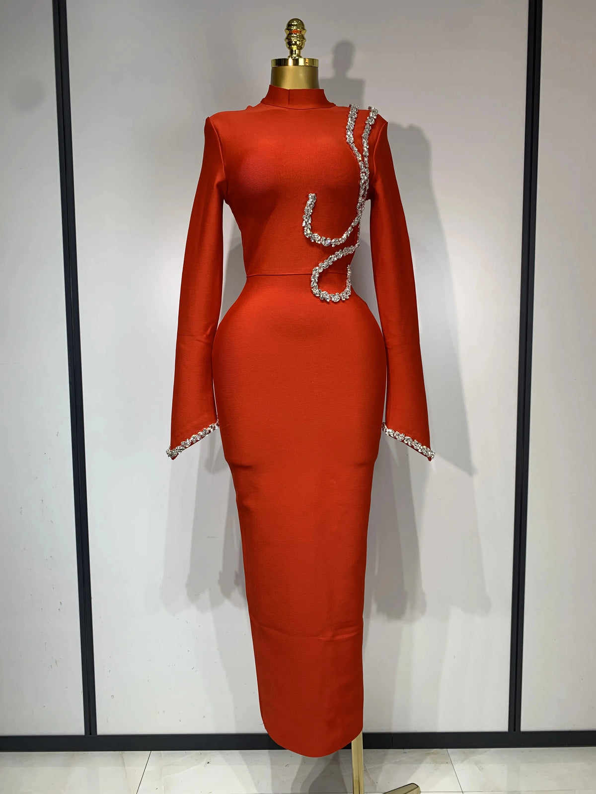 Red long-sleeve bodycon maxi dress featuring a high neckline and sparkling rhinestone embellishments.