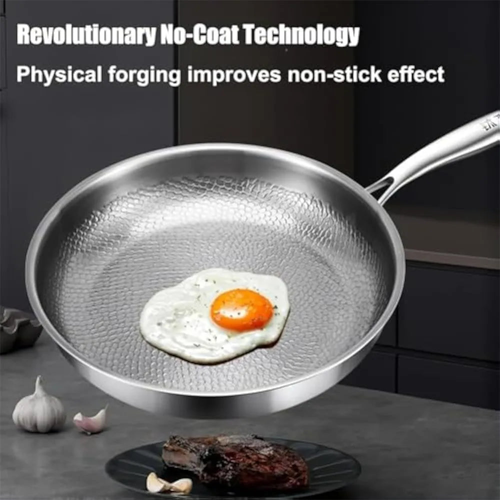 Stainless steel pan with a textured, hammered interior cooking surface containing a fried egg.