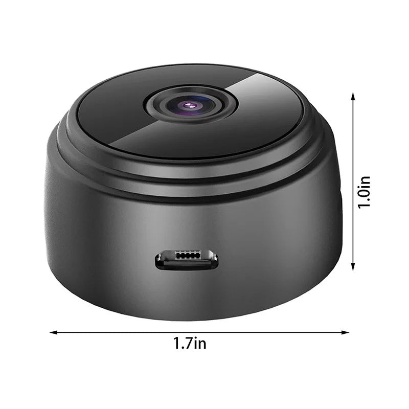 Small black plastic wireless security camera, circular shape, 1.7 inches wide and 1 inch high with a micro-USB port.