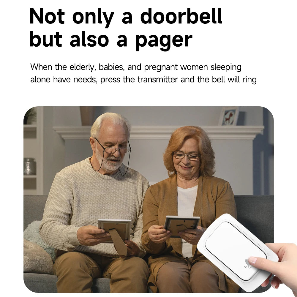 White, sleek wireless doorbell transmitter being held by hand, with an elderly couple sitting on a sofa in the background.