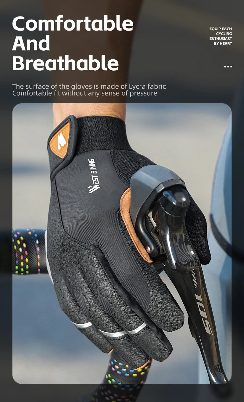 A person wearing black West Biking cycling gloves with orange accents while holding a Shimano bike brake lever.