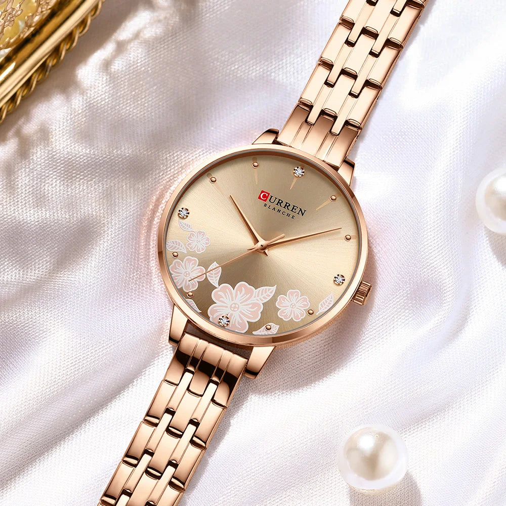 Rose gold Curren women's quartz watch with round dial, metal strap, and pink floral details.