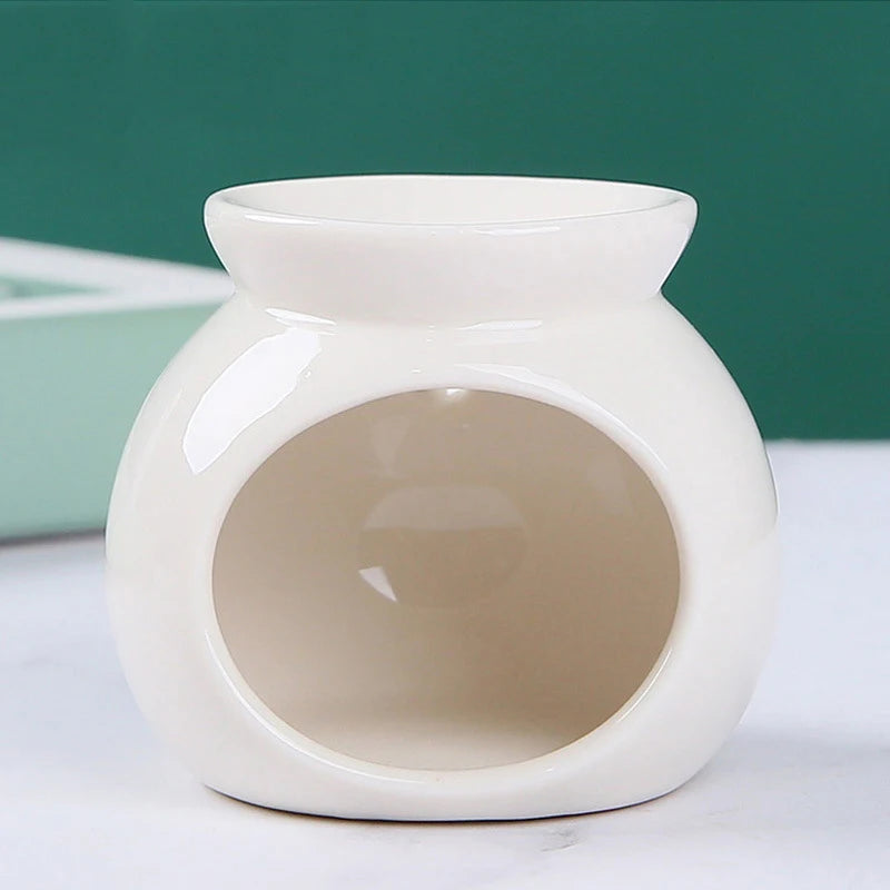 Glossy white ceramic oil burner with a rounded bowl shape and wide front opening for a tea light candle.