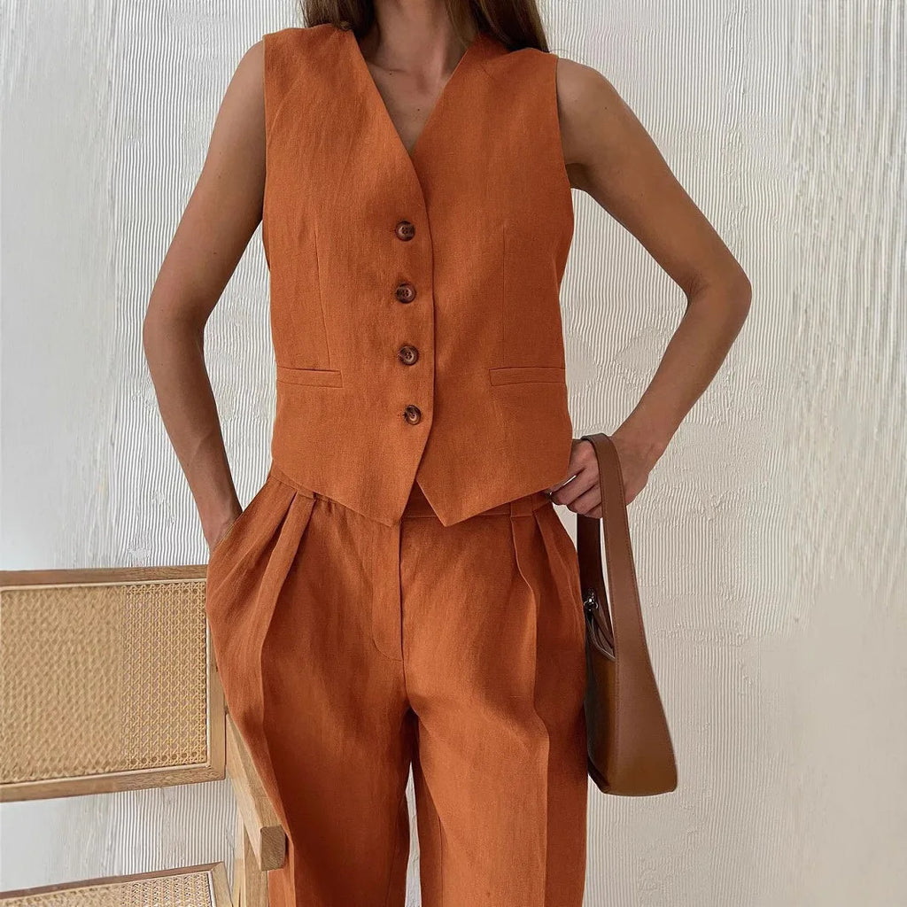 Rust orange tailored vest and matching high-waisted pleated trousers in a linen-look fabric.