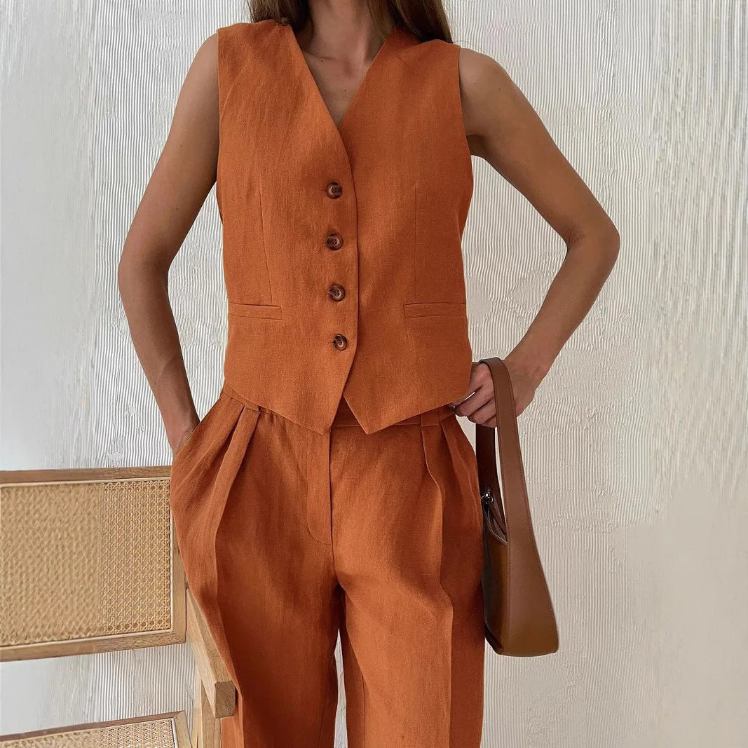 Rust orange tailored vest and matching high-waisted pleated trousers in a linen-look fabric.