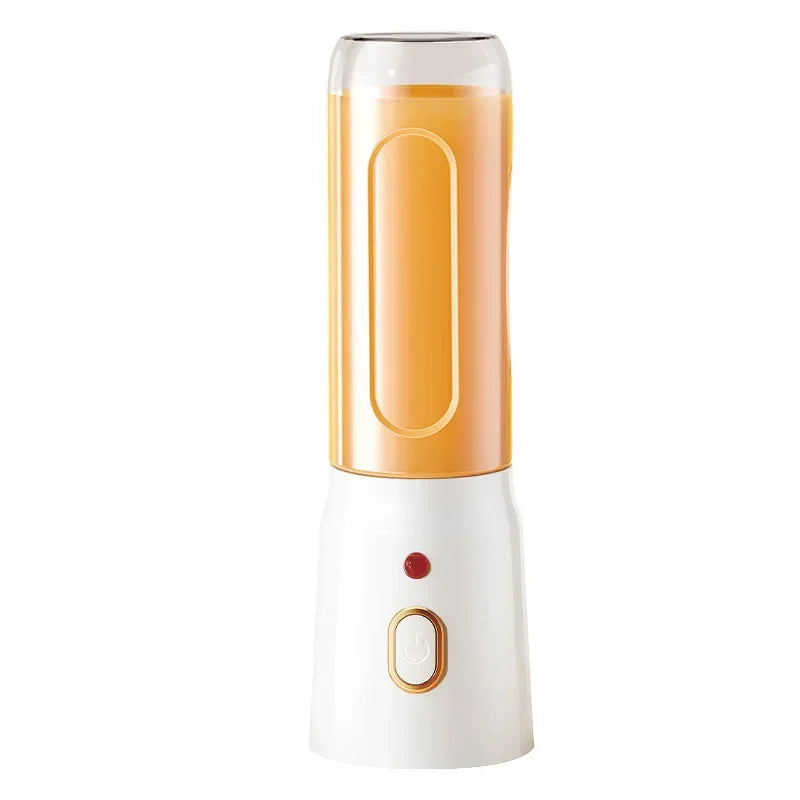 Portable blender with a white base, gold-trimmed power button, and a clear cup filled with orange liquid.