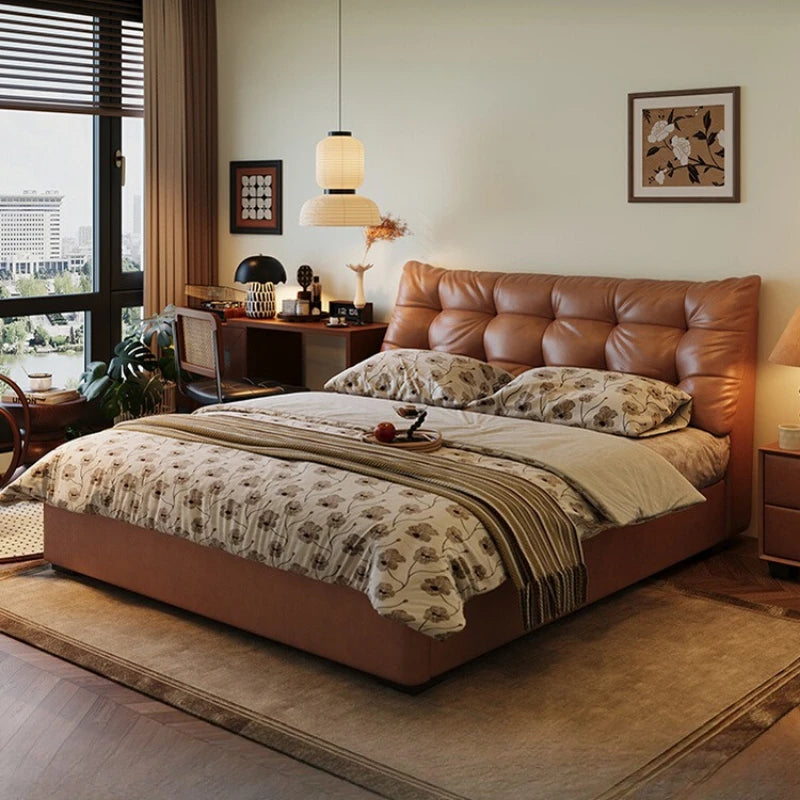 Modern Nordic double bed with a plush, tan tufted headboard in a cosy, stylishly decorated bedroom.