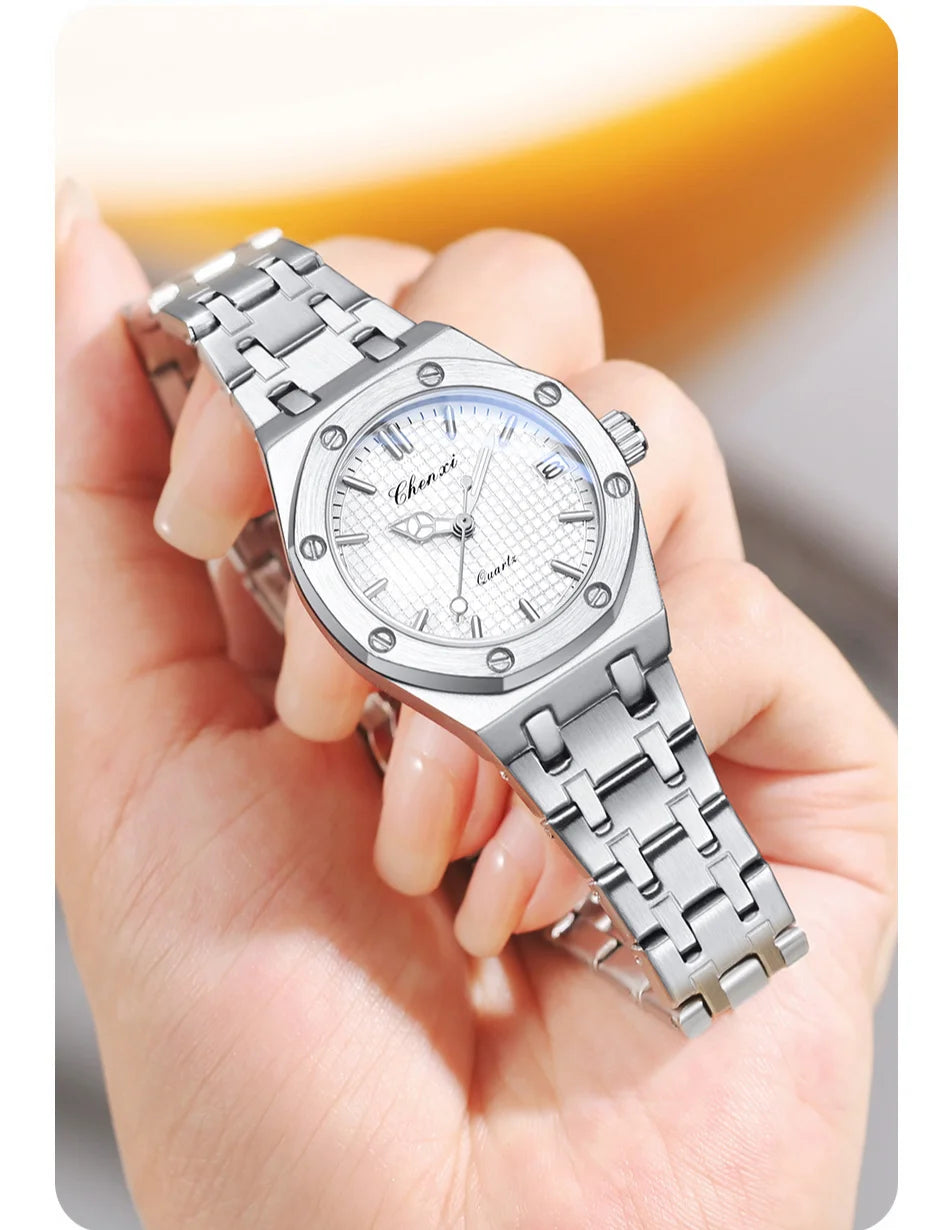 Elegant women's analogue watch in polished silver stainless steel with a textured face and screw-detailed bezel.
