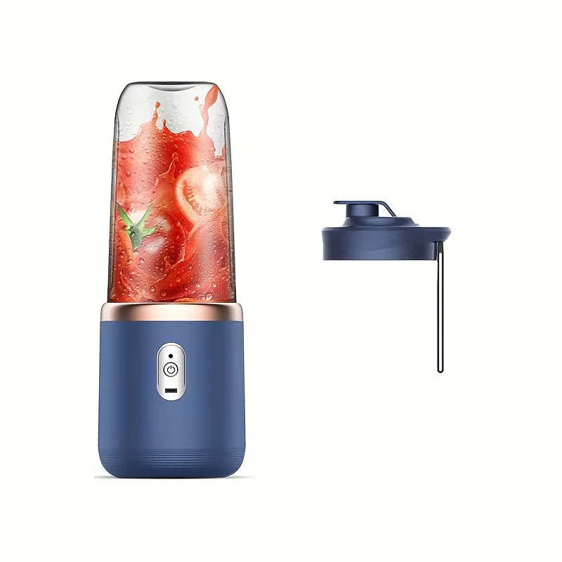 Portable navy blue blender with a clear cup containing tomato juice, rose gold accents, and a matching lid.