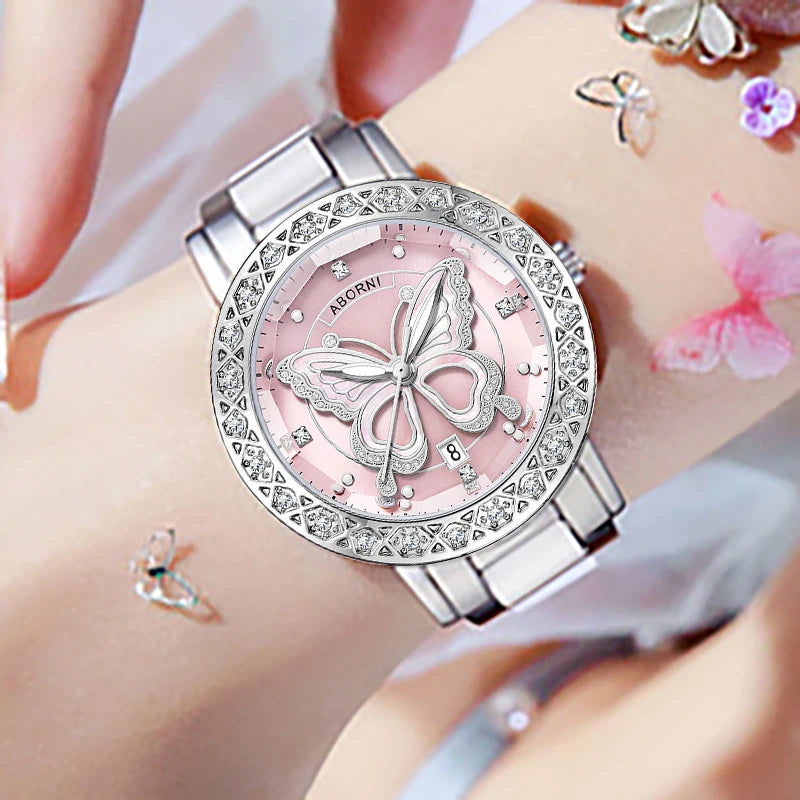 Luxury silver-tone women's watch featuring a pink dial with a butterfly motif and crystal-encrusted bezel.