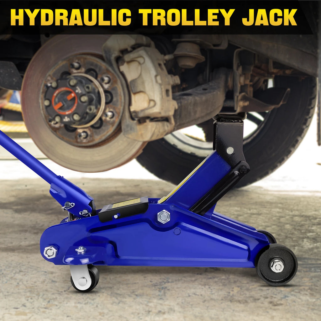 Blue steel hydraulic trolley floor jack lifting a car by the undercarriage, with caster and fixed wheels.