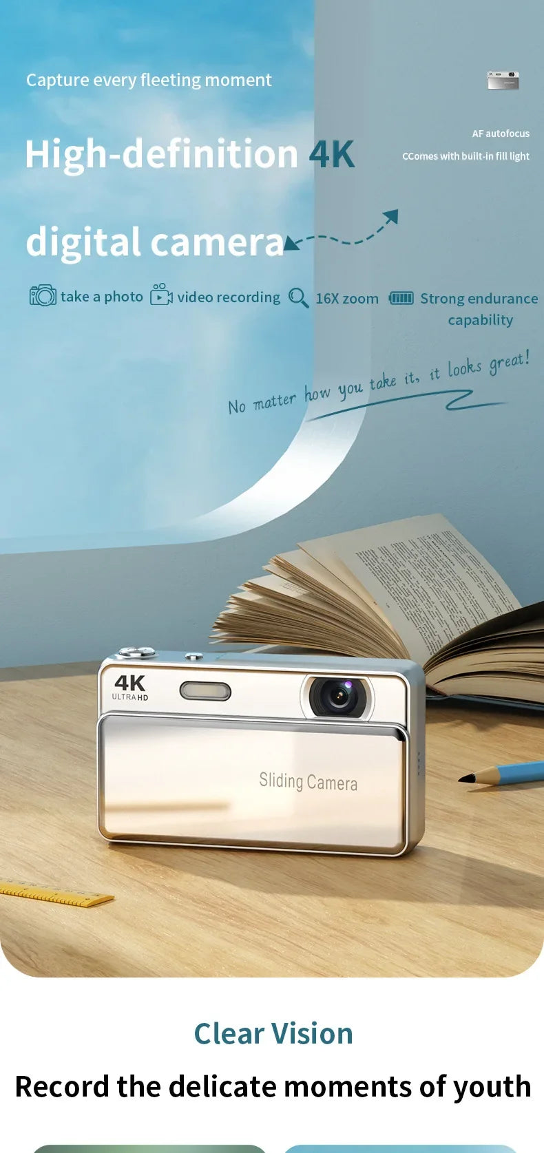 A slim, silver 4K digital camera with a sliding lens cover on a wooden desk next to an open book.
