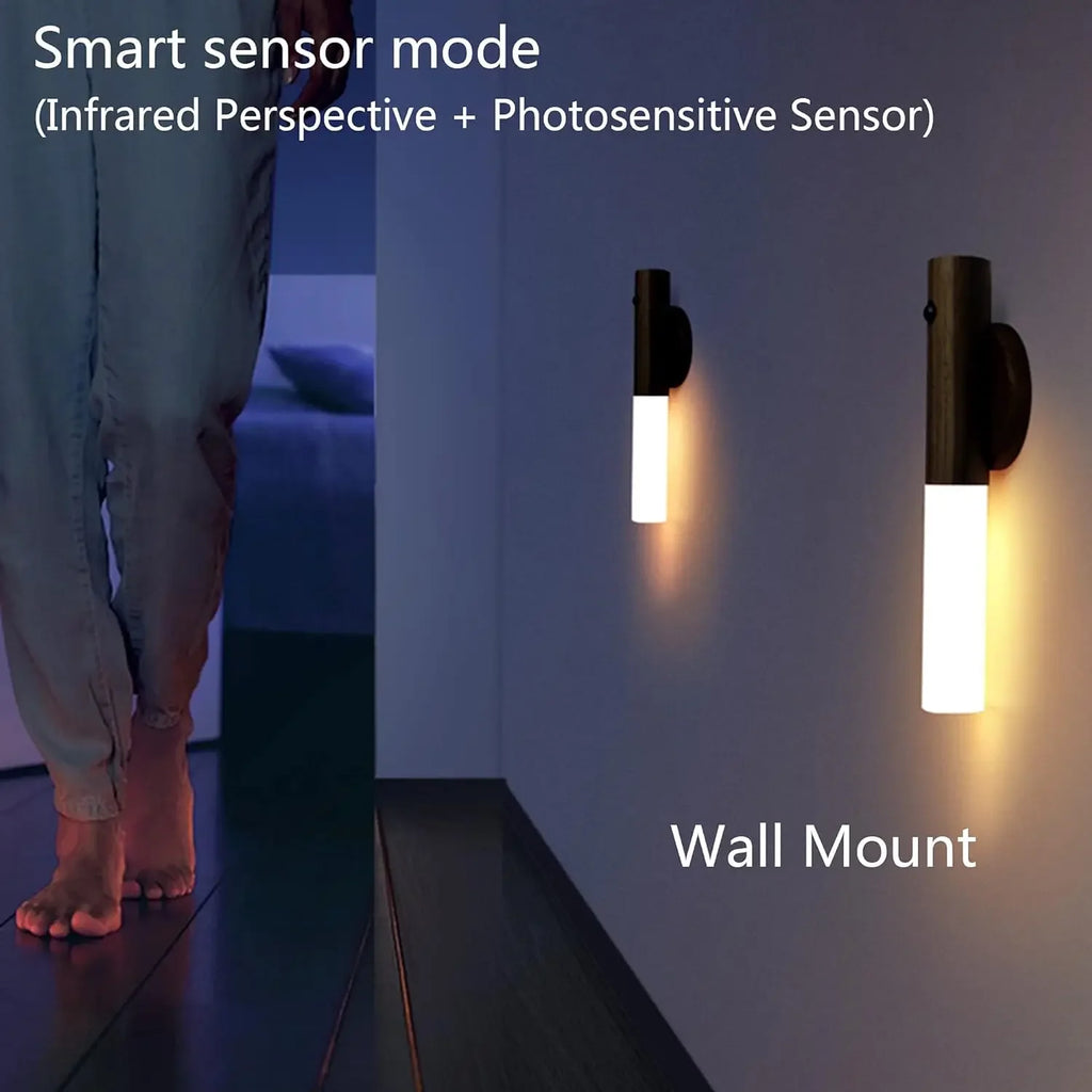 Two modern, dark-finish motion sensor LED lights mounted on a wall, glowing with a soft, warm light in a hallway.