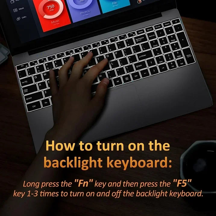 Dark grey 15.6-inch laptop with a backlit keyboard, showing instructions on how to toggle the light settings.