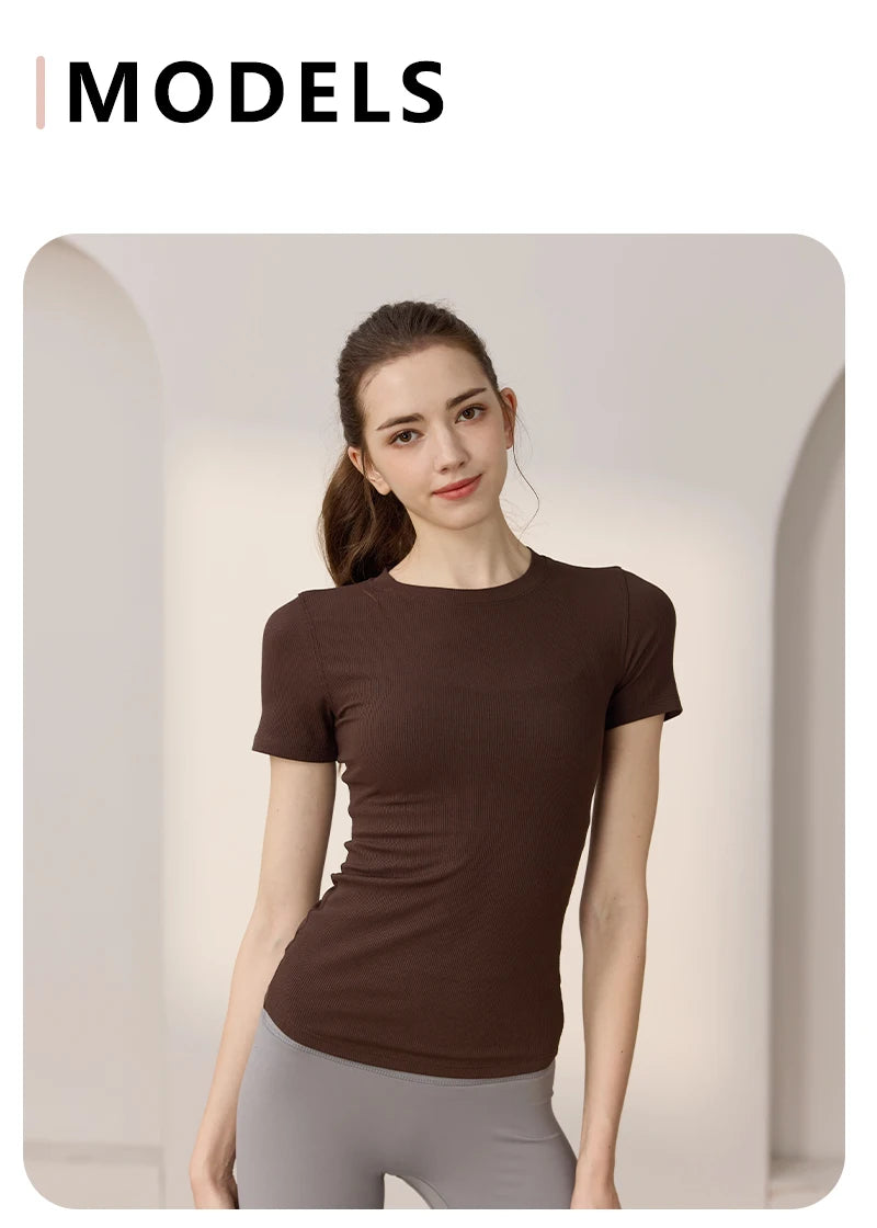 Model wearing a dark brown, short-sleeved, ribbed crew-neck T-shirt with a slim, fitted silhouette.