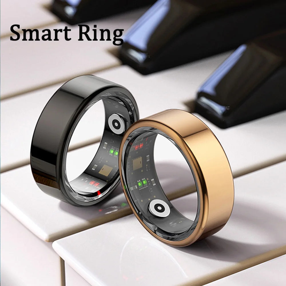 Black and gold smart fitness tracker rings with visible interior health sensors, resting on a piano keyboard.