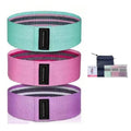 Three fabric hip resistance bands in mint green, pink, and purple, with black branded tags and a carry bag.