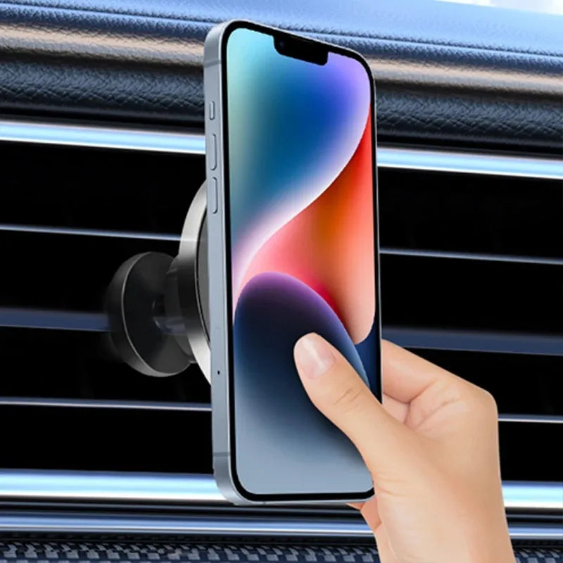 A silver magnetic phone mount attached to a car air vent, holding a smartphone with a colorful abstract display.
