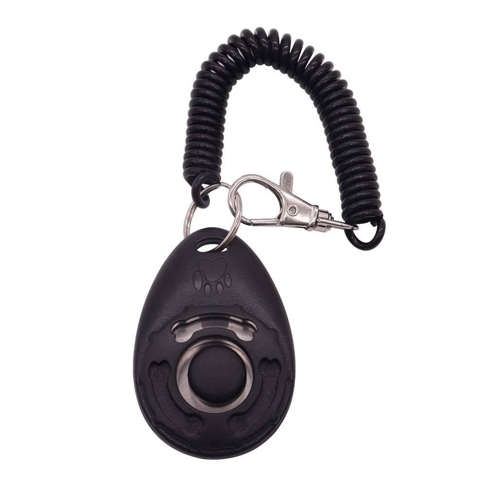 Black egg-shaped dog training clicker with a central button, featuring a paw print and a coiled wrist strap.