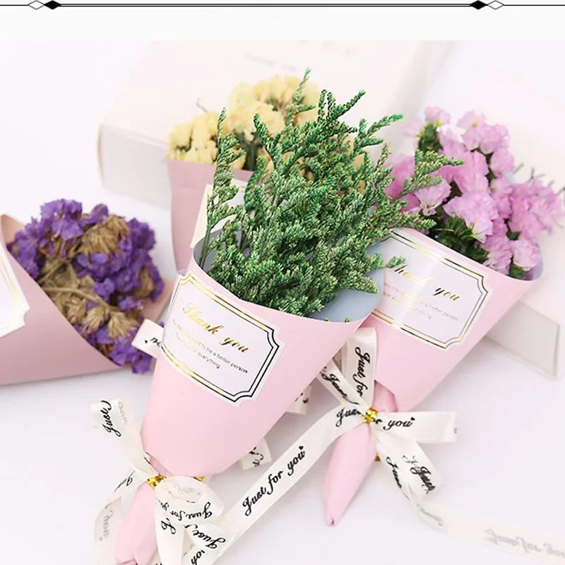 Small artificial flower bouquets in pastel paper cones with "Thank you" labels and "Just for you" ribbon ties.