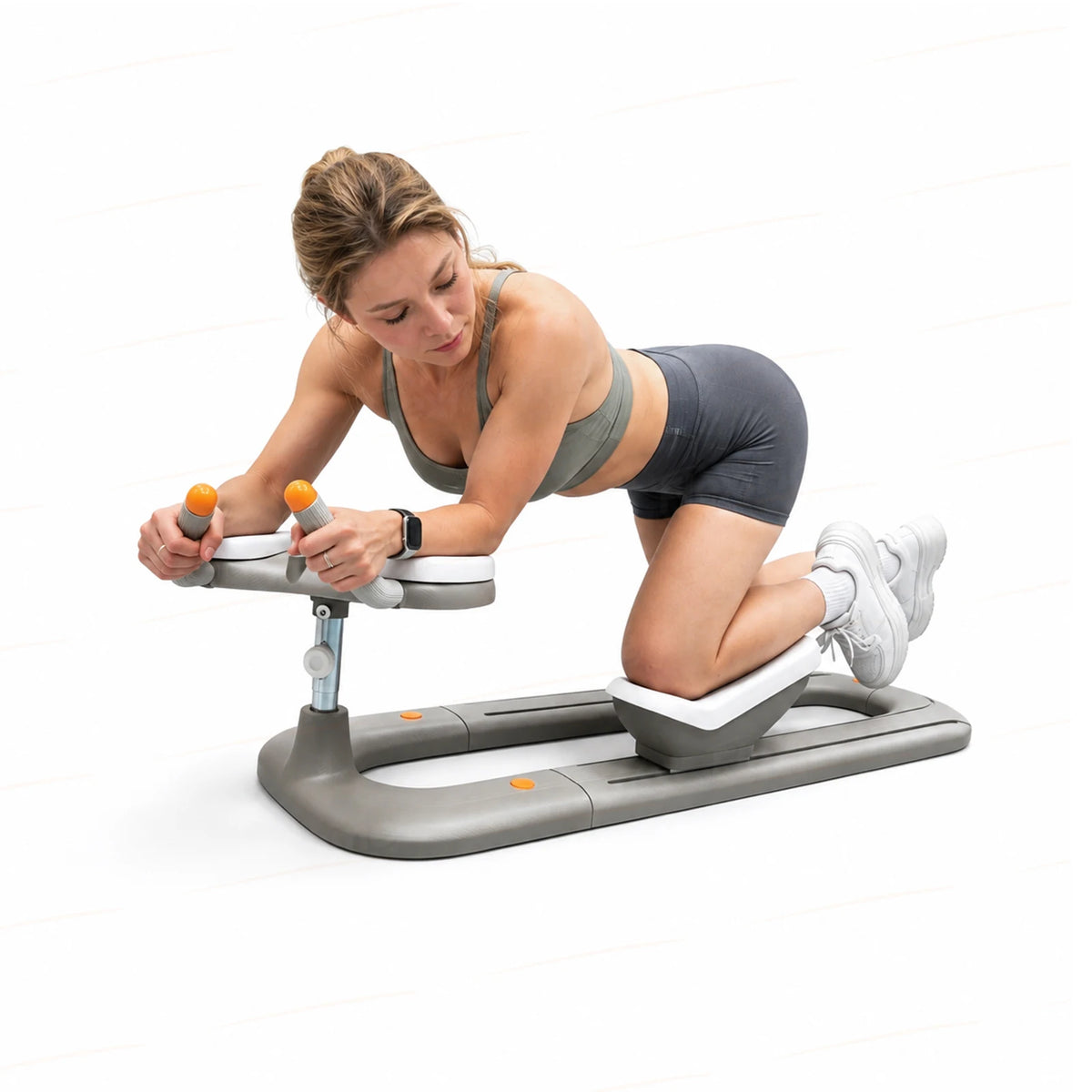 Woman using gray and white portable fitness crawling machine with orange-capped handles.