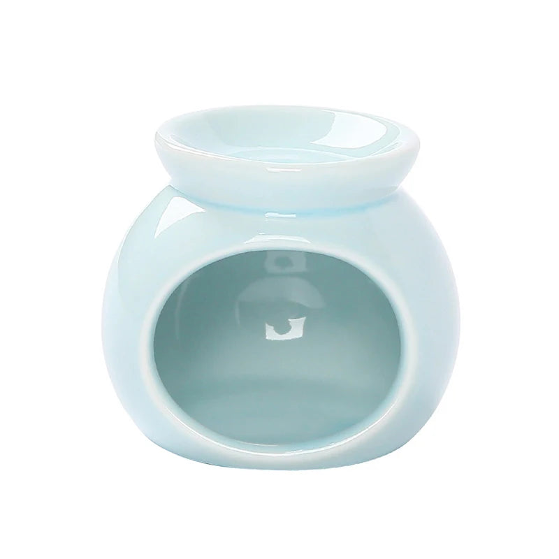 Pale blue ceramic oil burner with a rounded body and a bowl top for fragrance oils or wax melts.