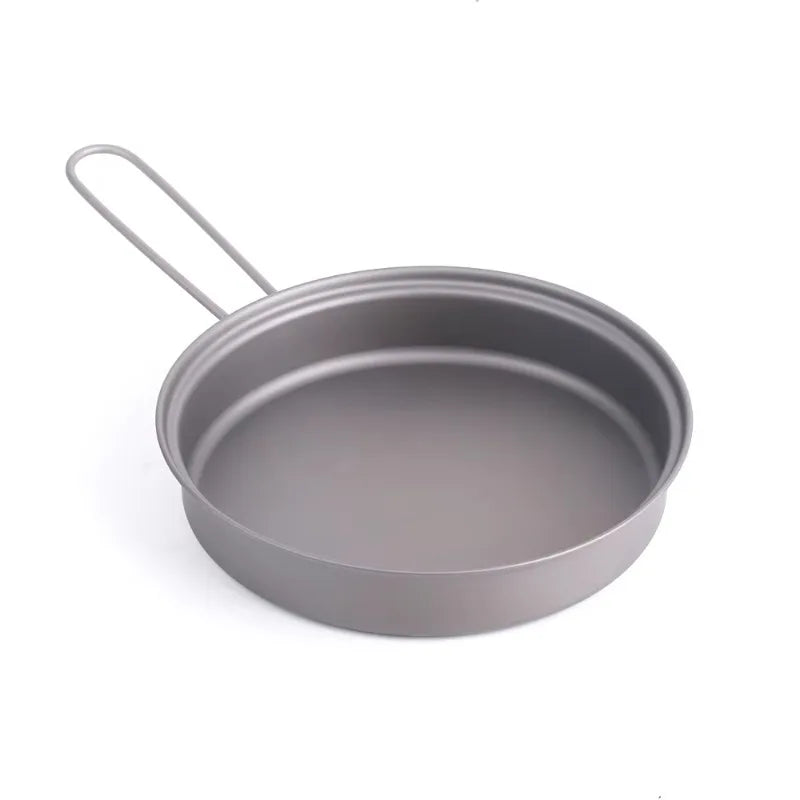 A round, gray metal camping pan with a thin wire folding handle against a white background.