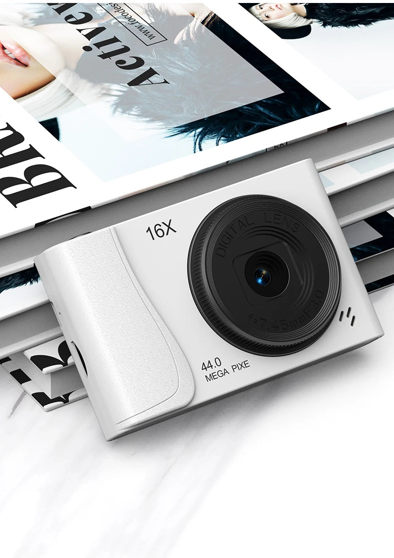 White digital camera with a 16x zoom lens, 44-megapixel sensor, and textured plastic body.