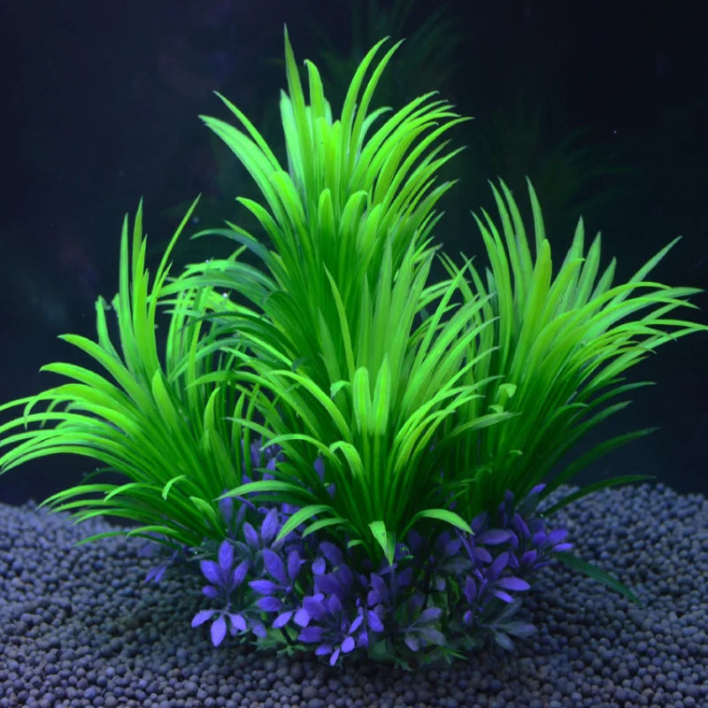 Artificial aquarium plant with tall, bright green grass-like blades and purple leaves at the base on dark gravel.