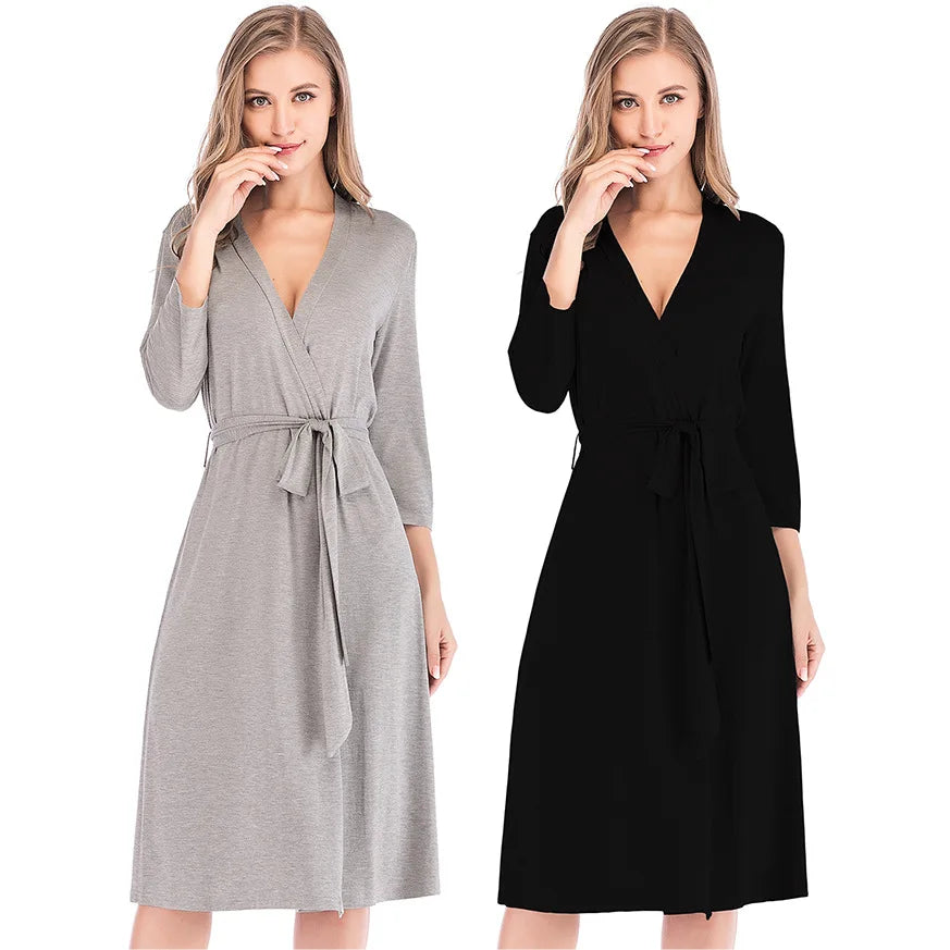 Two models wearing knee-length jersey wrap robes with tie waists, available in grey and black.