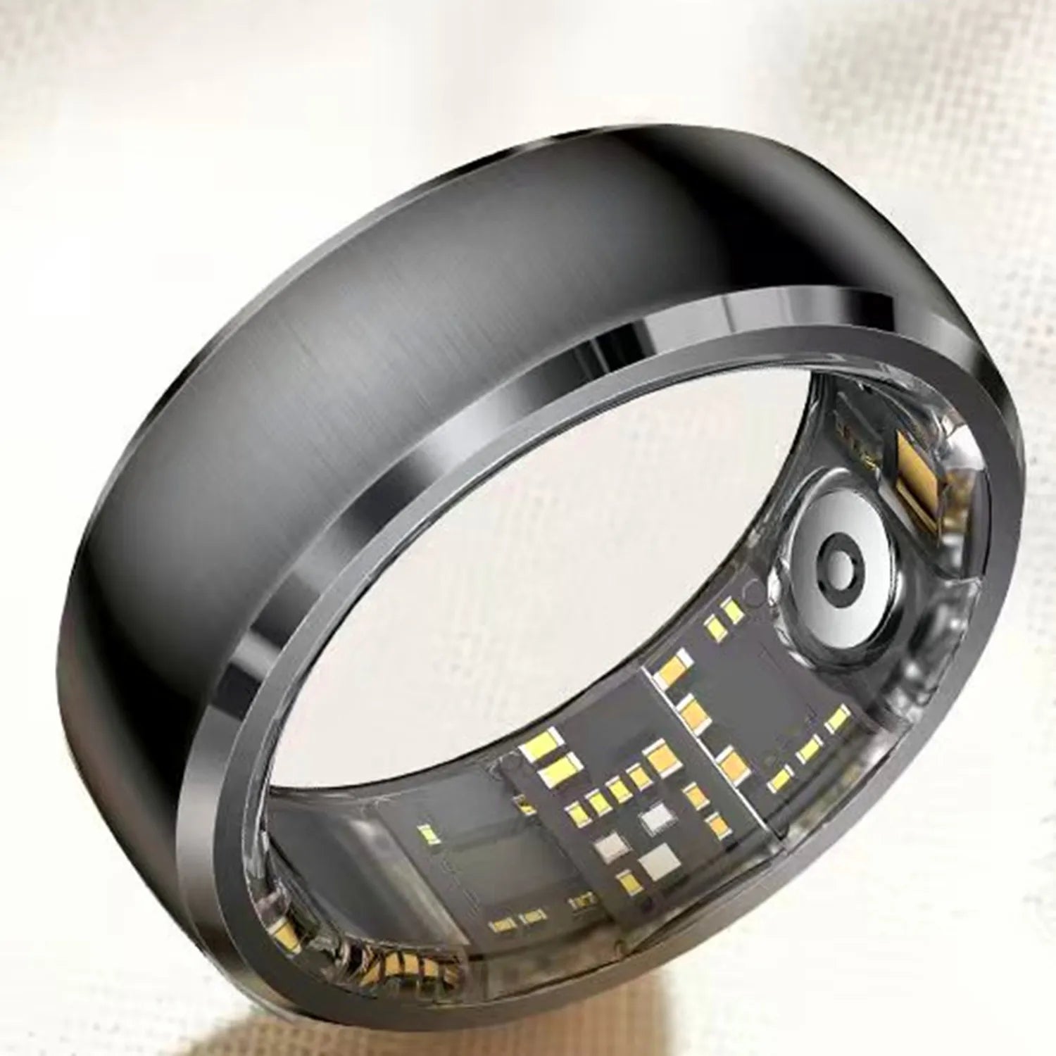 Sleek, brushed black smart fitness ring showing the inner electronic sensors and charging contact points.