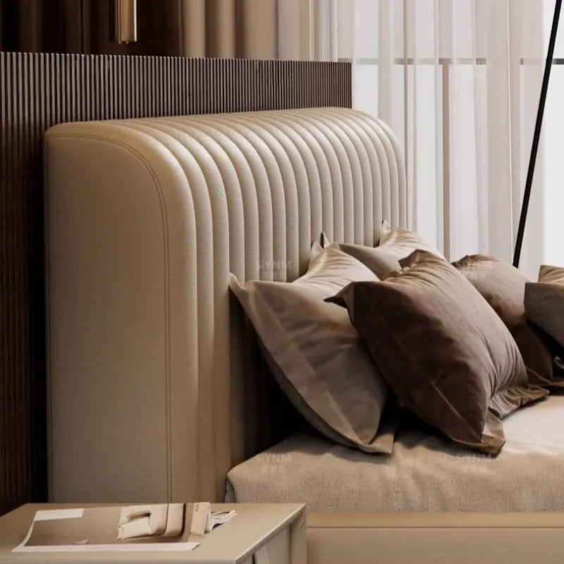 Modern cream storage bed with a vertical channel-tufted upholstered headboard, styled with soft brown cushions.