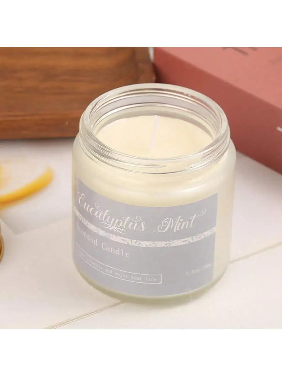 Eucalyptus Mint scented candle in a clear glass jar with a grey label.