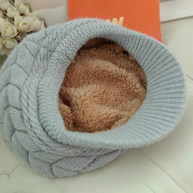 Pale blue cable-knit winter hat with a soft, brown faux-fur lining, shown from an angled top-down view.