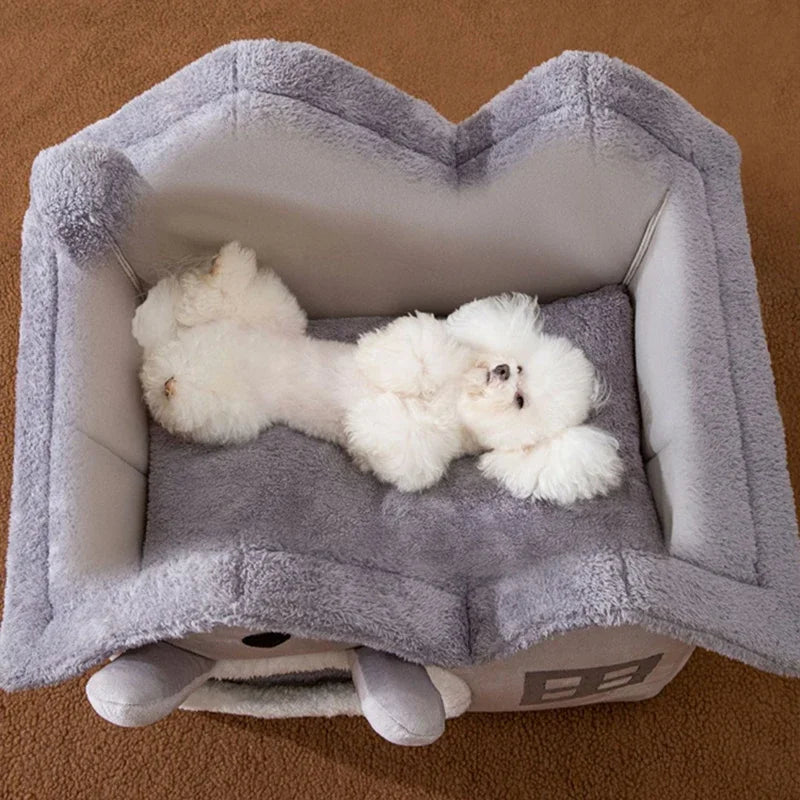 Grey plush foldable pet house with high walls and a matching cushion, holding a white puppy.
