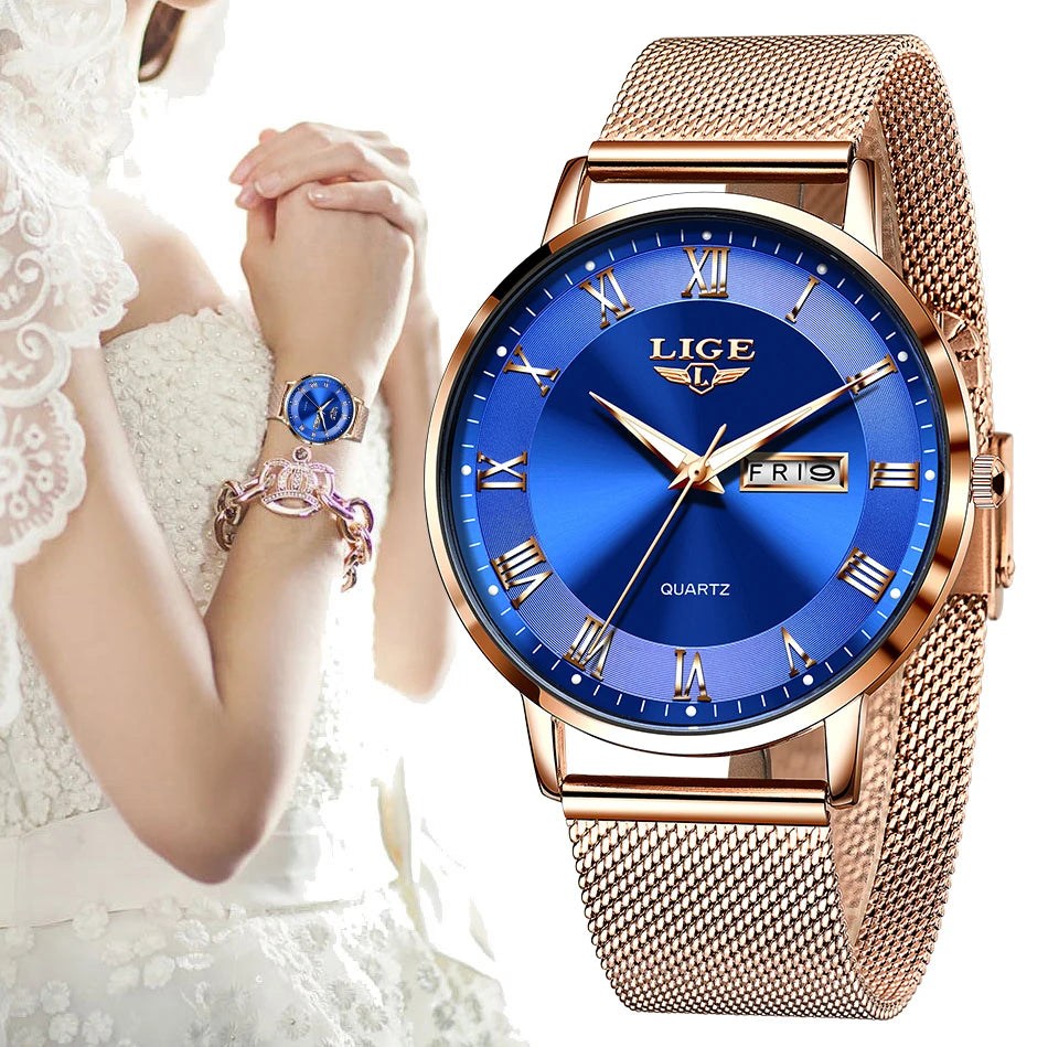 Elegant rose gold mesh bracelet watch for women with a vibrant blue dial, Roman numerals and day-date display.