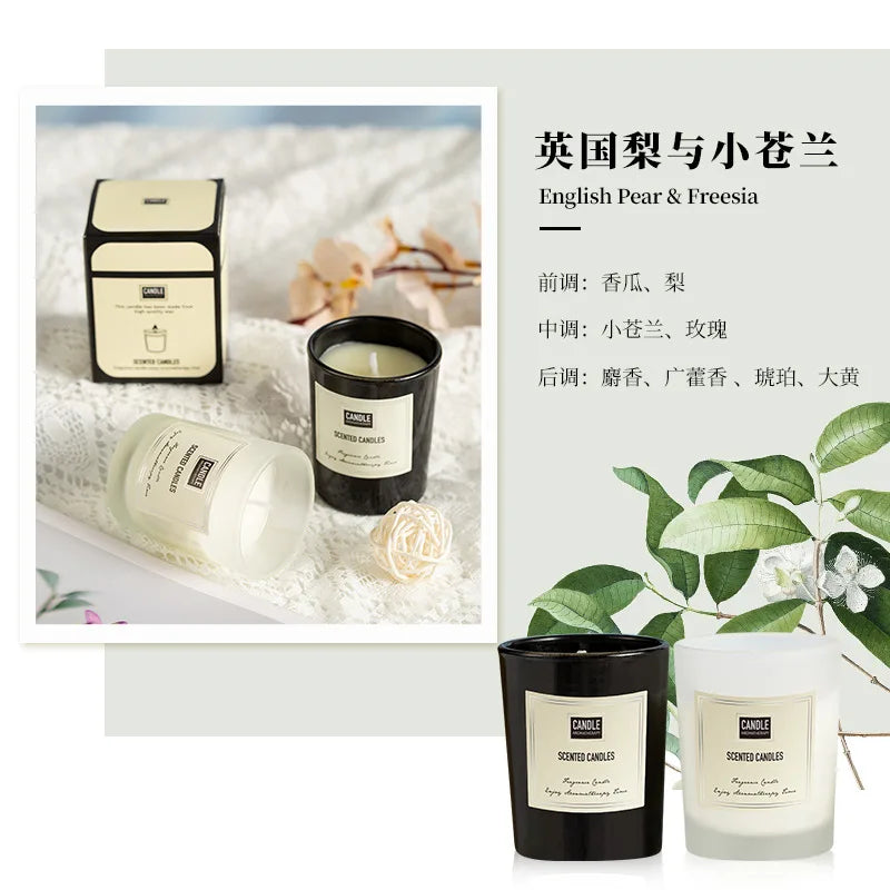English Pear and Freesia scented candles in black and frosted glass jars with cream labels and a matching gift box.