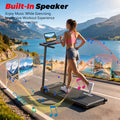 Black folding treadmill with digital display, being used outdoors by a woman running on a scenic coastal road.