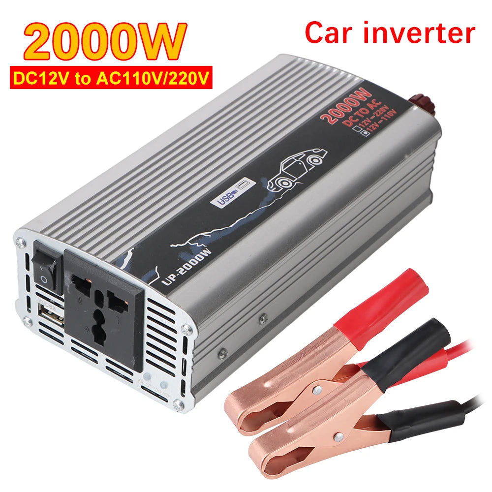 Silver 2000W car power inverter with a UK socket, USB port, and red and black battery connector clamps.