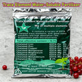 Shiny silver and dark green pouch of water-soluble trace element fertilizer for plants on a grey surface.