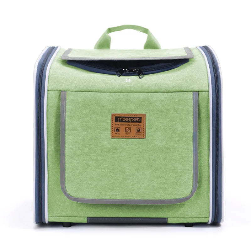 Green pet carrier backpack with a structured square form, zippered top opening, and a branded front pocket.