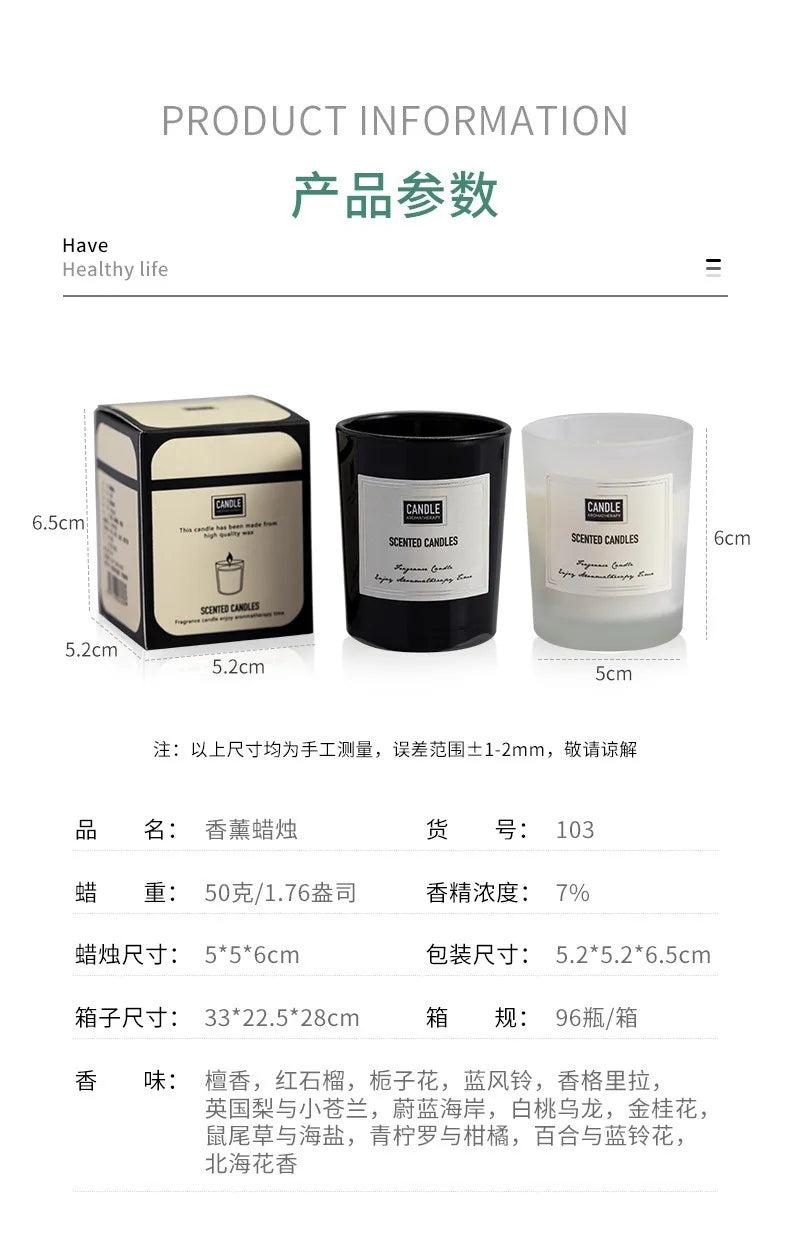 Set of two 50g scented candles in black and frosted glass jars, shown with their cream and black presentation box.