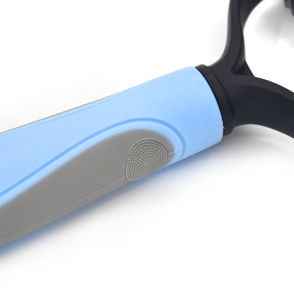 Close-up of a blue and grey pet grooming brush handle with a textured thumb grip.