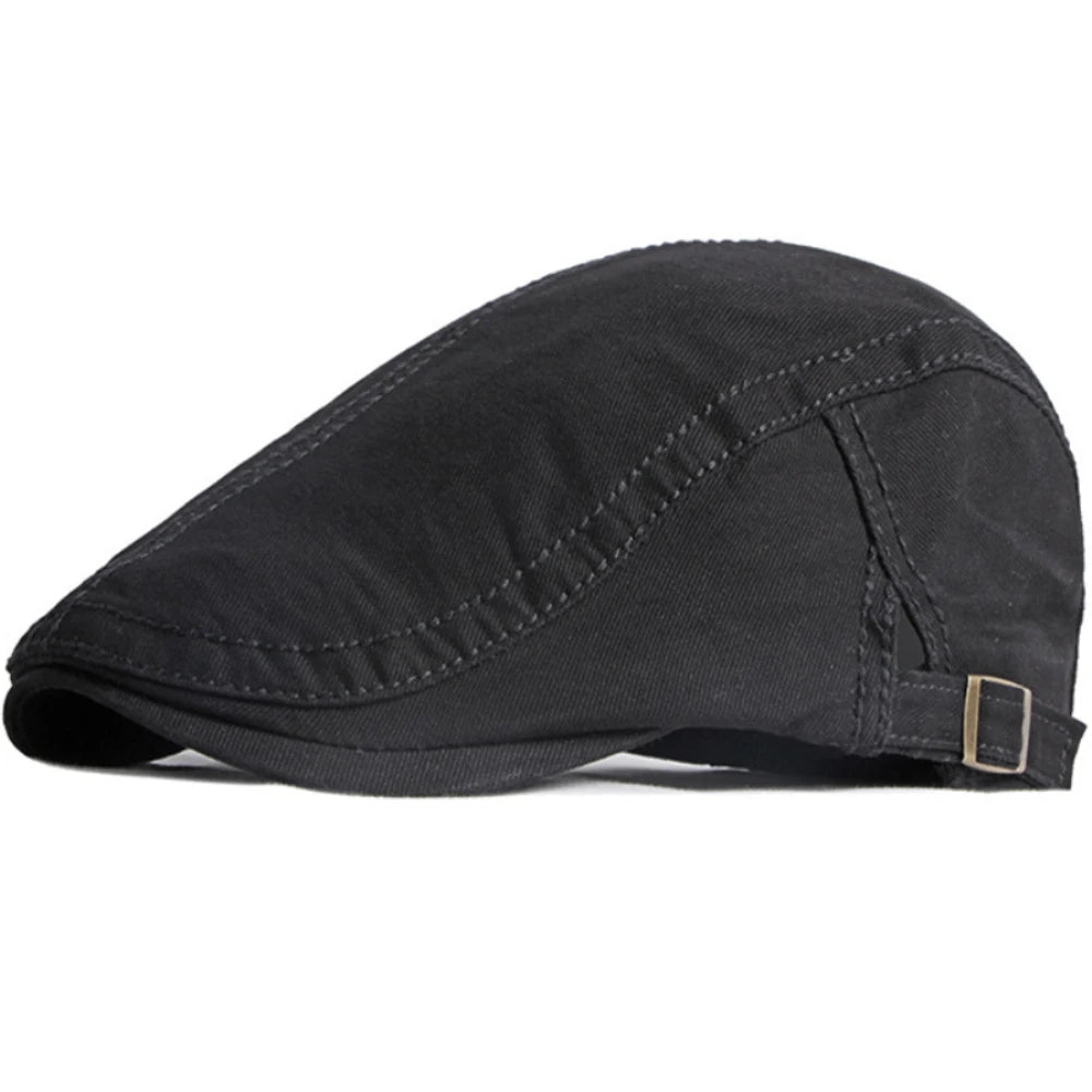 Black unisex cotton flat cap with a structured peak and an adjustable side buckle strap.