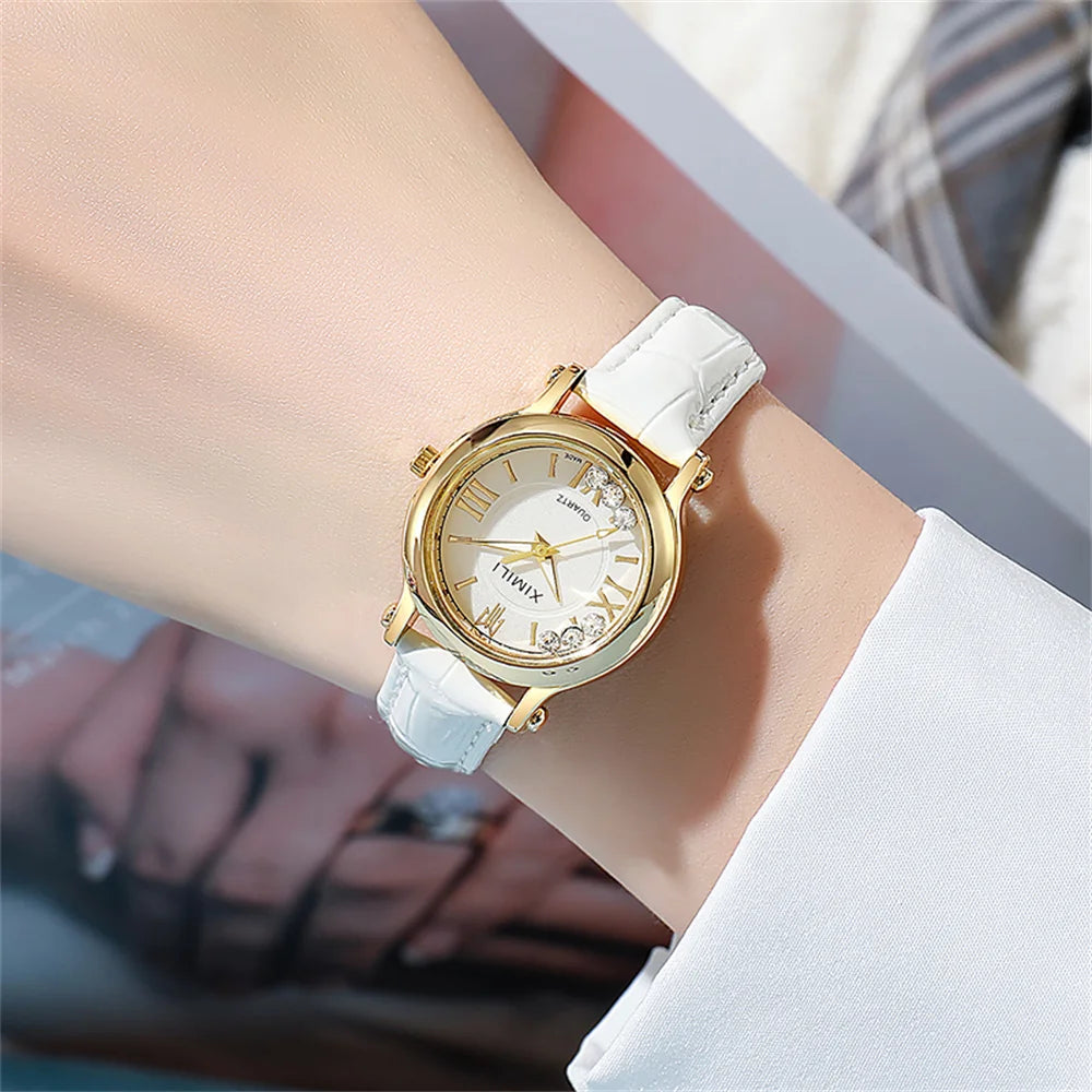 Women's quartz watch with a white croc-effect leather strap, gold-tone case, and crystal accents on a white dial.