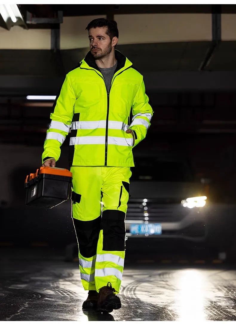 Man wearing a neon yellow hi-vis waterproof jacket and trousers with reflective stripes and black contrast panelling.