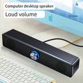 Sleek black wired USB stereo soundbar featuring a central volume dial with blue LED lighting on a computer desk.